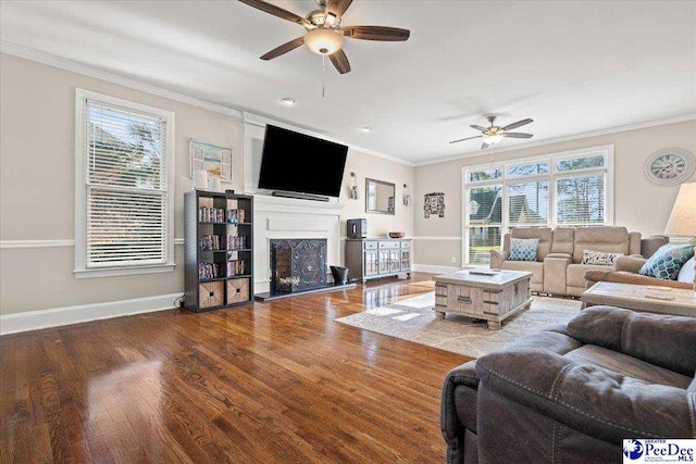 living area featuring crown molding and wood finished floors