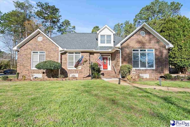 view of front of home featuring brick siding, crawl space, a shingled roof, and a front lawn