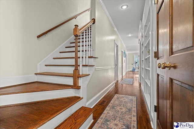 stairs with recessed lighting, crown molding, and wood finished floors