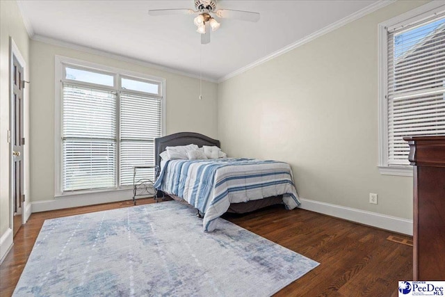 bedroom featuring multiple windows, wood finished floors, baseboards, and ornamental molding