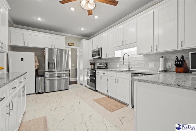 kitchen featuring crown molding, white cabinets, marble finish floor, and appliances with stainless steel finishes