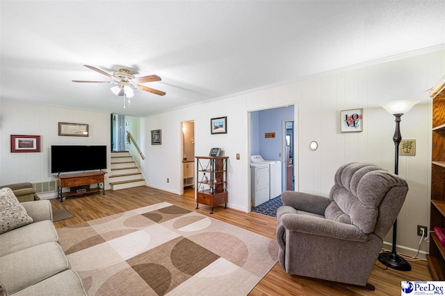 908 Clarendon Ave, Florence, SC 29505 - living room with washing machine and clothes dryer, a ceiling fan, wood finished floors, stairs, and ornamental molding