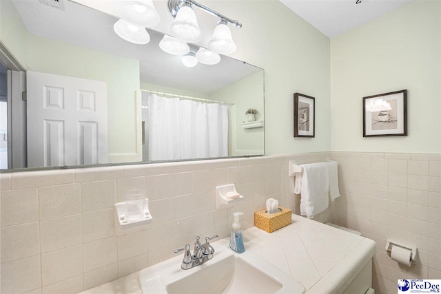 908 Clarendon Ave, Florence, SC 29505 - bathroom featuring tile walls and vanity