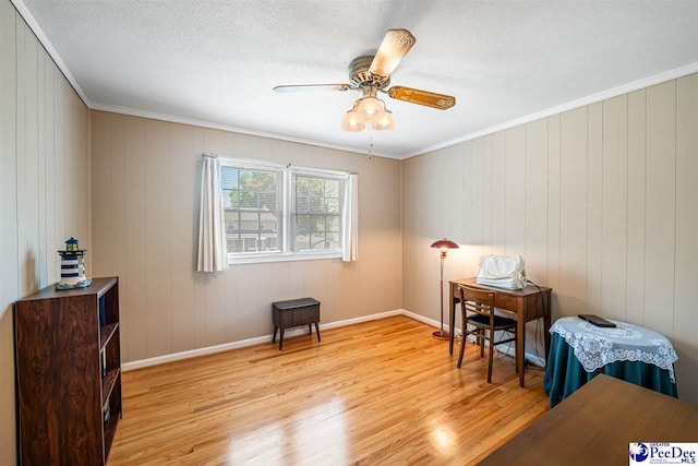 908 Clarendon Ave, Florence, SC 29505 - sitting room featuring light wood-style flooring, a ceiling fan, crown molding, baseboards, and a textured ceiling
