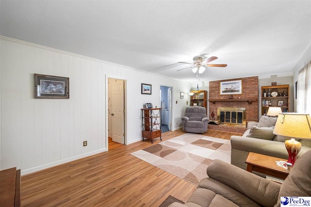 908 Clarendon Ave, Florence, SC 29505 - living area featuring light wood finished floors, ceiling fan, baseboards, a fireplace, and ornamental molding