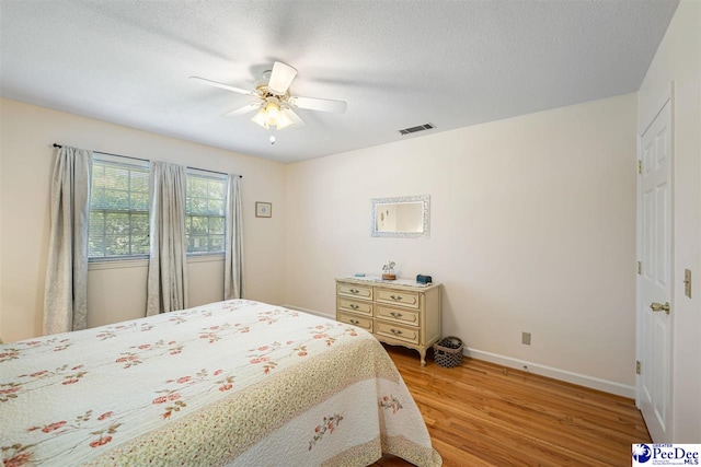 908 Clarendon Ave, Florence, SC 29505 - bedroom featuring wood finished floors, baseboards, a ceiling fan, and a textured ceiling