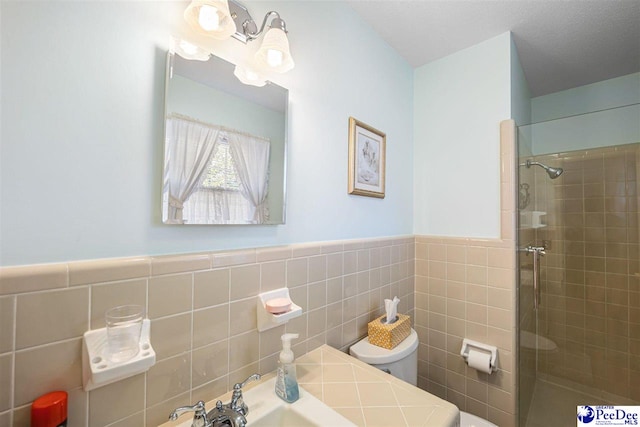 908 Clarendon Ave, Florence, SC 29505 - full bathroom featuring toilet, tile walls, tiled shower, a wainscoted wall, and a sink