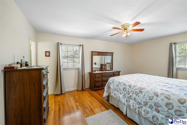 908 Clarendon Ave, Florence, SC 29505 - bedroom with light wood-type flooring, baseboards, and a ceiling fan