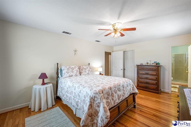 908 Clarendon Ave, Florence, SC 29505 - bedroom with baseboards, light wood-type flooring, ensuite bath, and a ceiling fan