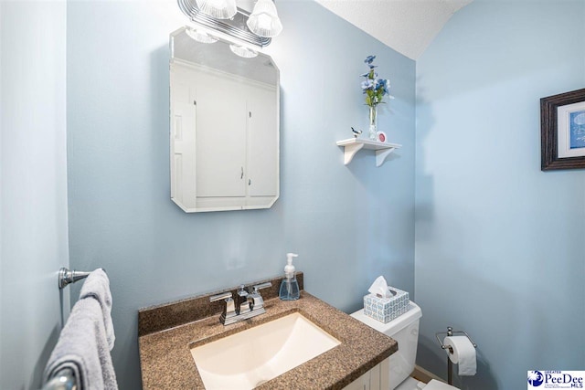908 Clarendon Ave, Florence, SC 29505 - bathroom with vanity, toilet, and lofted ceiling
