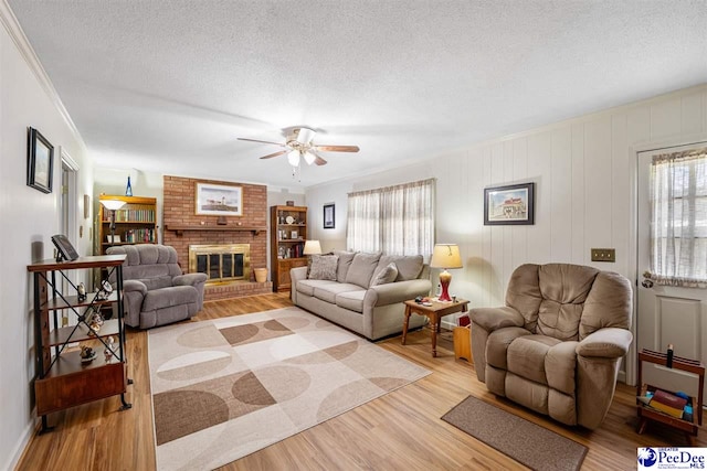 908 Clarendon Ave, Florence, SC 29505 - living room with plenty of natural light, light wood finished floors, a textured ceiling, and a ceiling fan