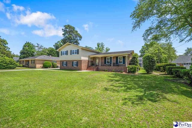 908 Clarendon Ave, Florence, SC 29505 - tri-level home featuring brick siding and a front lawn