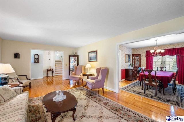 908 Clarendon Ave, Florence, SC 29505 - living area with a chandelier, wood finished floors, stairway, and baseboards