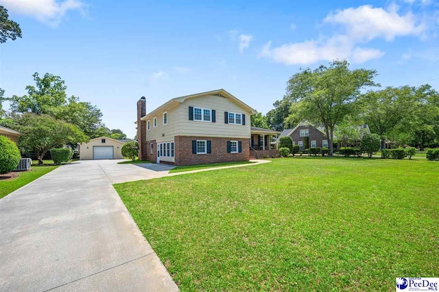 908 Clarendon Ave, Florence, SC 29505 - tri-level home featuring driveway, a detached garage, brick siding, a chimney, and a front lawn