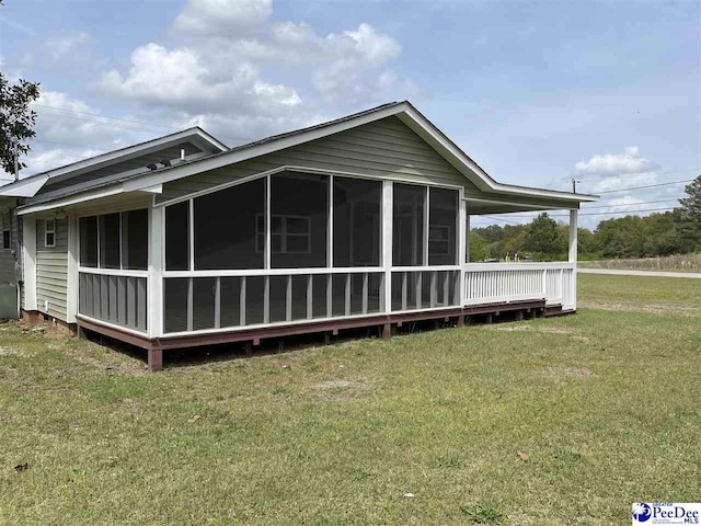 1429 E Home Ave, Hartsville, SC 29550 - rear view of house with a sunroom and a lawn