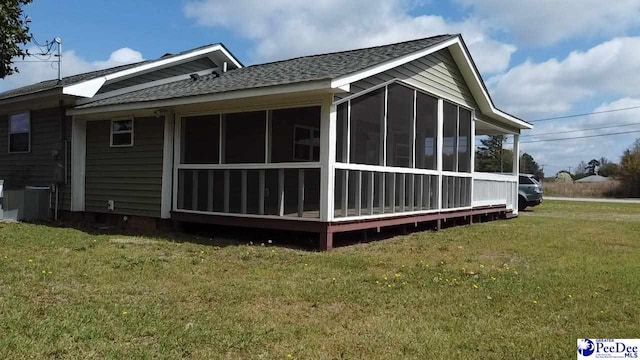 1429 E Home Ave, Hartsville, SC 29550 - view of side of property featuring a shingled roof, a lawn, and a sunroom