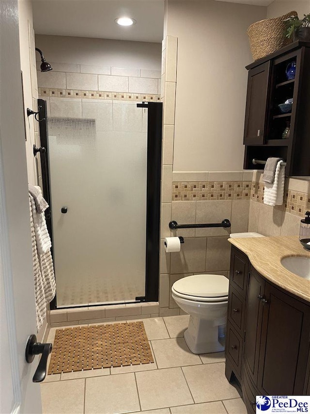 1429 E Home Ave, Hartsville, SC 29550 - full bathroom with a stall shower, tile patterned flooring, toilet, tile walls, and vanity