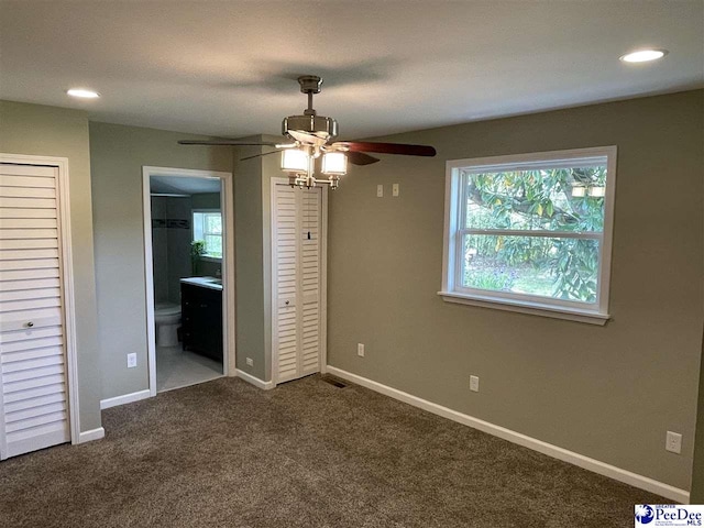 1429 E Home Ave, Hartsville, SC 29550 - unfurnished bedroom featuring dark carpet, baseboards, connected bathroom, recessed lighting, and ceiling fan