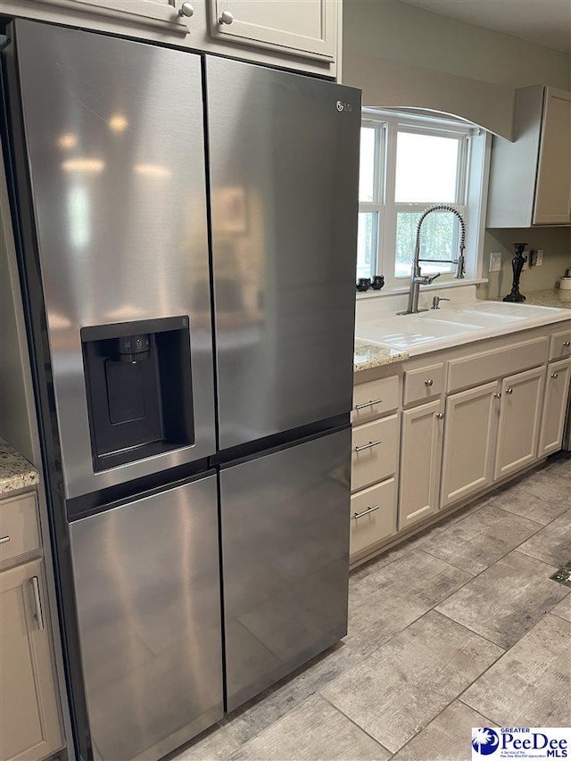 1429 E Home Ave, Hartsville, SC 29550 - kitchen featuring stainless steel fridge with ice dispenser, a sink, and light stone counters