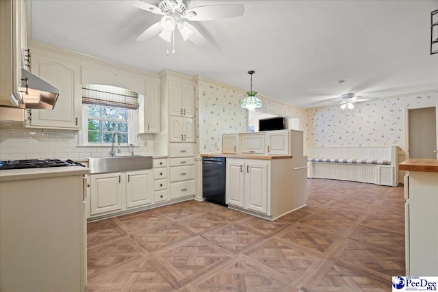 kitchen featuring wallpapered walls, ceiling fan, under cabinet range hood, black appliances, and a sink