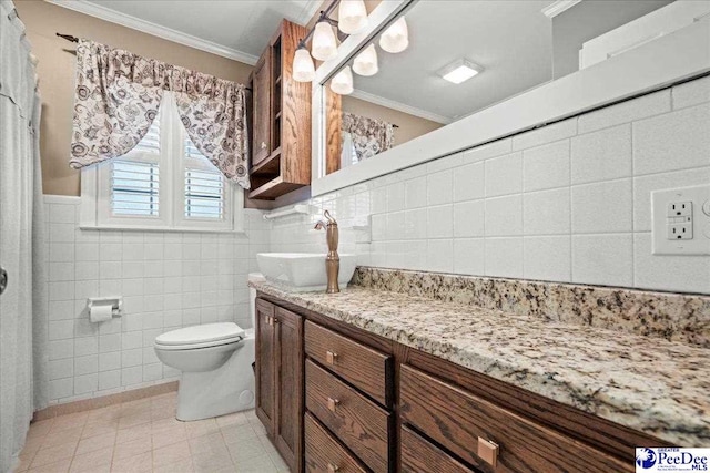 full bath with toilet, tile walls, crown molding, and vanity