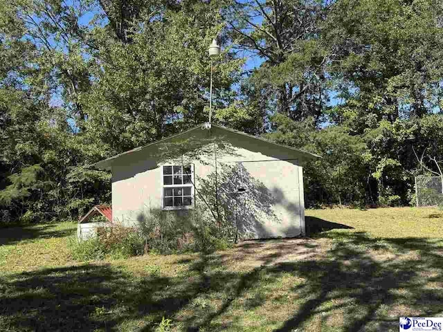 view of home's exterior featuring a storage shed and a lawn