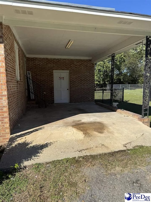 view of vehicle parking with a carport