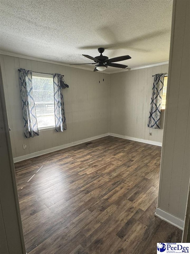 empty room with ceiling fan, dark hardwood / wood-style floors, and a textured ceiling