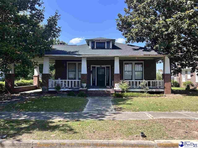 204 Witcover St, Marion, SC 29571 - view of front of house featuring brick siding, covered porch, and a front yard