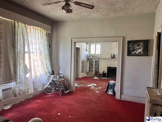 204 Witcover St, Marion, SC 29571 - living area with carpet flooring, a ceiling fan, a textured ceiling, and a fireplace