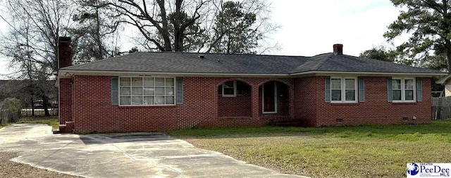 ranch-style home featuring brick siding, crawl space, a front lawn, a chimney, and a patio area