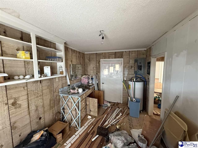 misc room with electric panel, gas water heater, and a textured ceiling