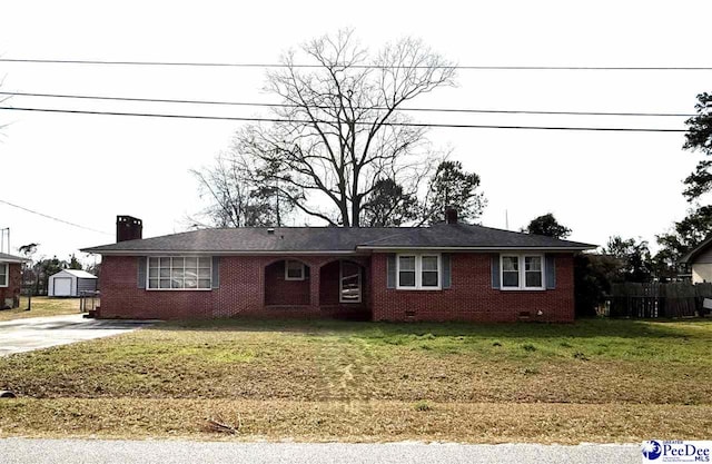 single story home with brick siding, an outdoor structure, driveway, crawl space, and a front lawn