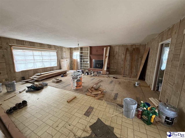 unfurnished living room featuring a brick fireplace