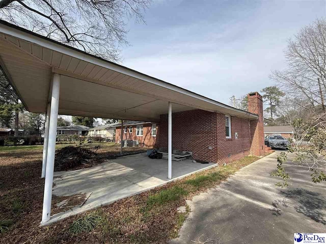 view of parking / parking lot featuring a carport