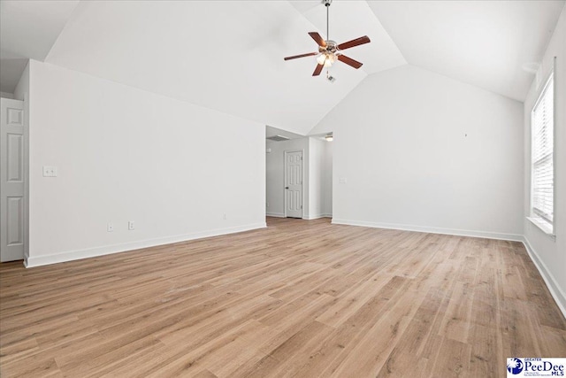 interior space featuring lofted ceiling, baseboards, a ceiling fan, and light wood-style floors