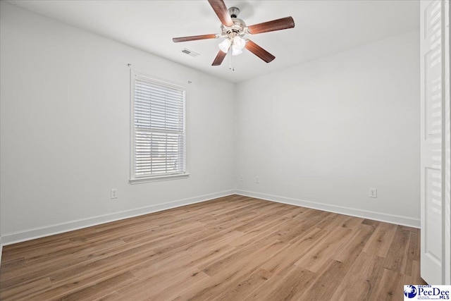 unfurnished room featuring baseboards, ceiling fan, visible vents, and light wood finished floors