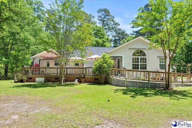 rear view of property with a wooden deck, a yard, and crawl space
