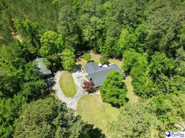 bird's eye view with a wooded view