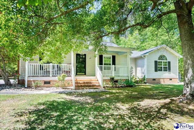 view of front of home featuring a front lawn, covered porch, and crawl space