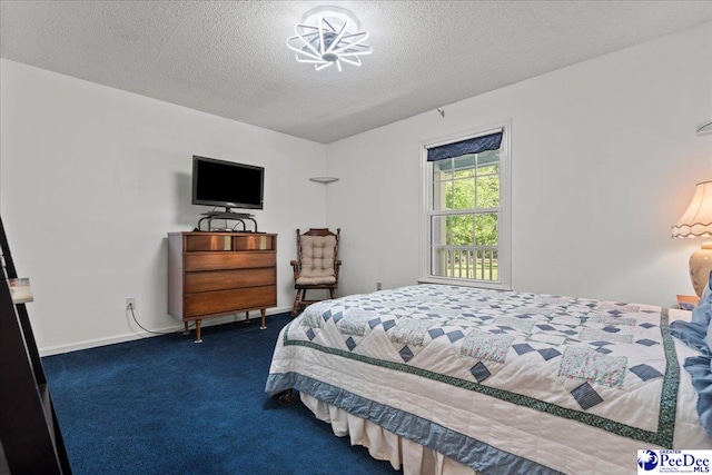 carpeted bedroom with a textured ceiling