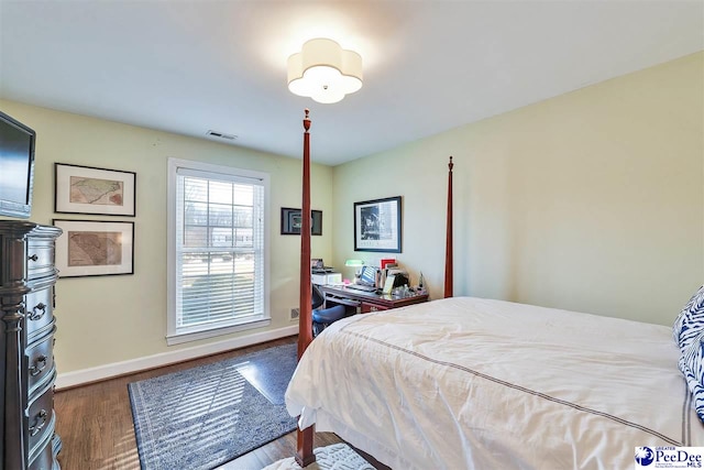 bedroom with dark wood-type flooring