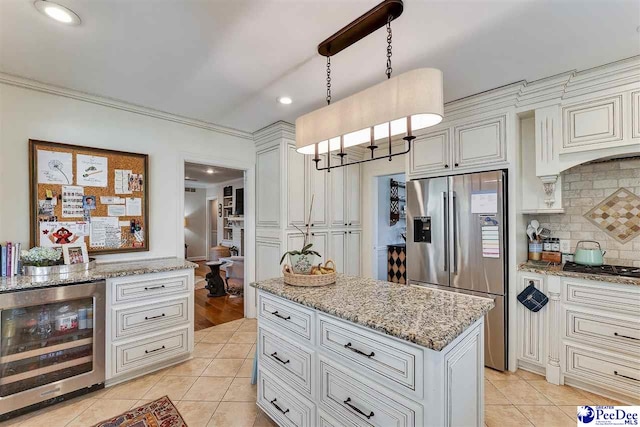 kitchen with wine cooler, light tile patterned flooring, light stone counters, pendant lighting, and stainless steel appliances