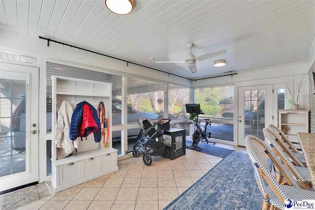 sunroom featuring ceiling fan