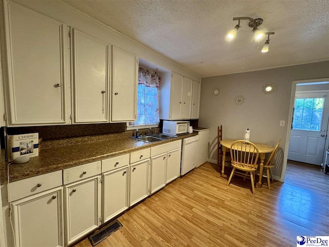 66 Victory Dr, Cheraw, SC 29520 - kitchen featuring white appliances, healthy amount of natural light, a textured ceiling, a sink, and white cabinets