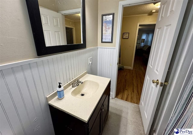 66 Victory Dr, Cheraw, SC 29520 - bathroom with vanity, a wainscoted wall, and crown molding
