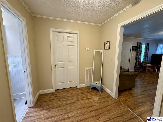 66 Victory Dr, Cheraw, SC 29520 - foyer entrance with wood finished floors, a textured ceiling, crown molding, and baseboards