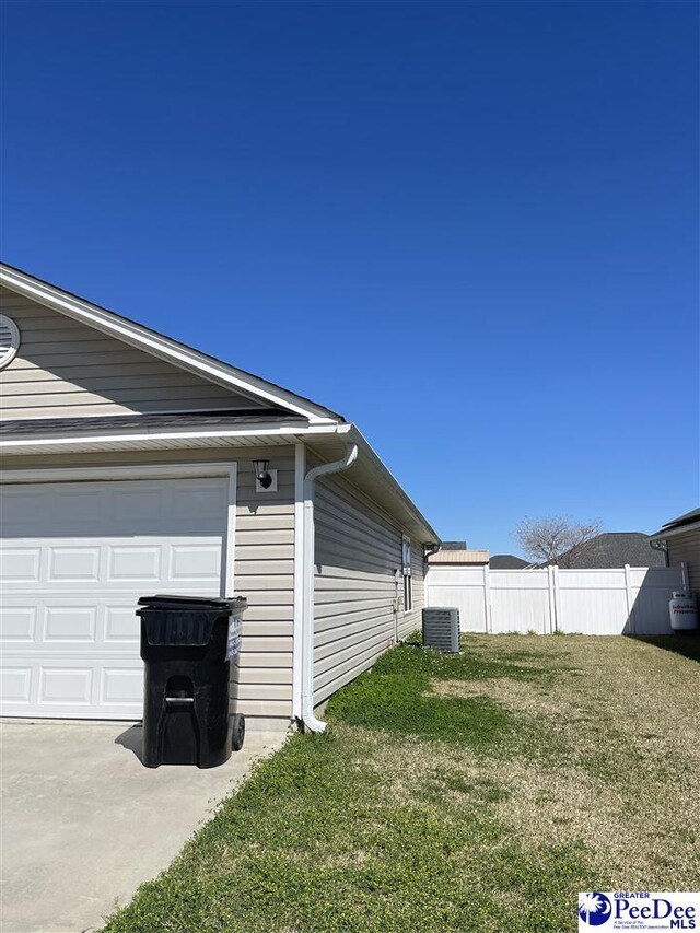 3007 Colton Dr, Florence, SC 29506 - view of side of home featuring a yard, central AC, and fence