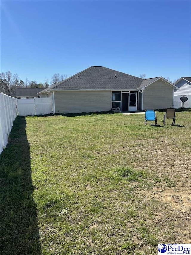 3007 Colton Dr, Florence, SC 29506 - back of property featuring a lawn, a fenced backyard, and a sunroom