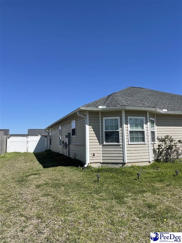 3007 Colton Dr, Florence, SC 29506 - view of home's exterior featuring a yard, roof with shingles, and fence